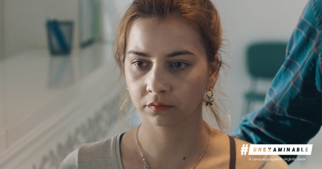 Romania-virginity-testing-2022 A focused shot of a teenage girl's face. Her expression is serious, troubled and upset. The caption reads,