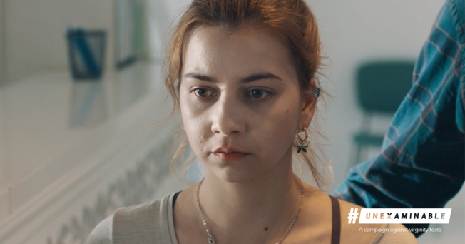 A focused shot of a teenage girls face. Her expression is serious, troubled and upset. The caption reads, #UnExaminable. A campaign against virginity tests.