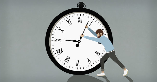 A person struggling to move the arms on a large clock