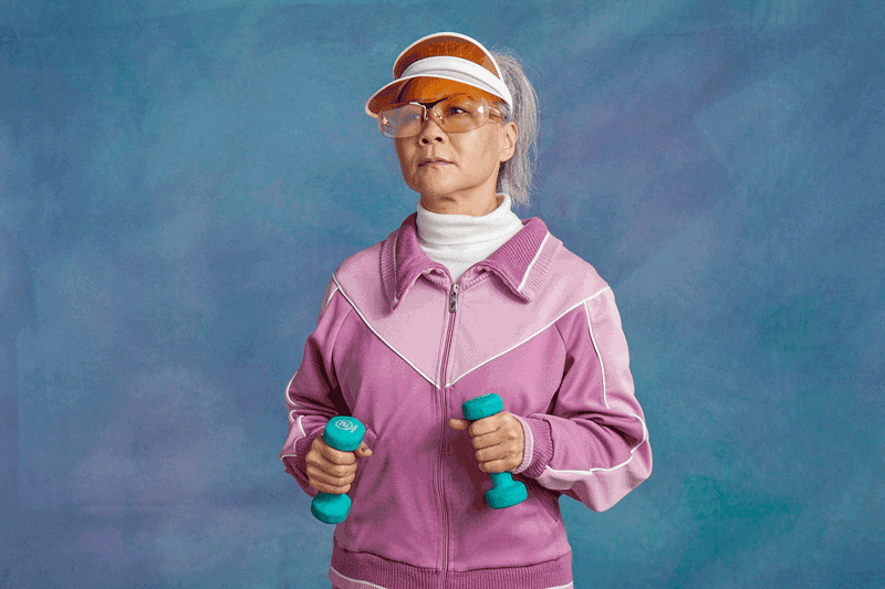 woman in exercising clothes holding weights