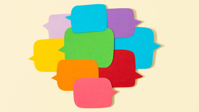 Multicolored speech bubbles over a beige background.